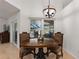 Dining area with a wood table set and a view of the pool and lanai at 222 Via Mariel E Dr, Davenport, FL 33896