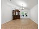 Dining room with tile floors, a chandelier, and a built-in china cabinet at 222 Via Mariel E Dr, Davenport, FL 33896