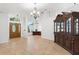 Open entryway with tile flooring, a wooden front door, and high ceilings at 222 Via Mariel E Dr, Davenport, FL 33896