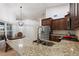 Spacious kitchen featuring granite countertops, stainless steel appliances, and an eat-in island at 222 Via Mariel E Dr, Davenport, FL 33896