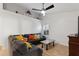 Inviting living room with a comfortable gray couch, decorative pillows, and a ceiling fan at 222 Via Mariel E Dr, Davenport, FL 33896