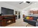 Open living space featuring an entertainment center and sliding glass doors to backyard at 222 Via Mariel E Dr, Davenport, FL 33896