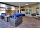 Relaxing covered patio with stylish outdoor furnishings, lighting, fan, and a fire pit at 222 Via Mariel E Dr, Davenport, FL 33896