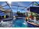 Beautiful pool with water features and lounge seating within a screened enclosure at 222 Via Mariel E Dr, Davenport, FL 33896