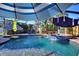 Outdoor screened-in pool area with lounge furnishings and colorful umbrellas for shade at 222 Via Mariel E Dr, Davenport, FL 33896
