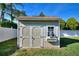 Spacious backyard storage shed with a window box and decorative trim at 222 Via Mariel E Dr, Davenport, FL 33896