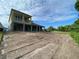 Expansive backyard with view from the rear of the home under partly cloudy sky at 2430 Francisco Art Ct, Oviedo, FL 32765