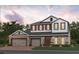 Charming two-story home with stone accents, three-car garage, and a welcoming front entrance at 2430 Francisco Art Ct, Oviedo, FL 32765