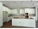 Spacious kitchen featuring white cabinets, a center island, and stainless steel vent hood at 2430 Francisco Art Ct, Oviedo, FL 32765