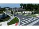 Neighborhood street view showcasing a landscaped community entrance and modernly designed homes at 2430 Francisco Art Ct, Oviedo, FL 32765