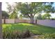 Well-maintained backyard with healthy grass, a large shade tree, and privacy fencing at 2936 Antique Oaks Cir # 71, Winter Park, FL 32792