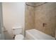 Bathroom featuring a tiled shower with a built-in nook and a low-flow toilet at 2936 Antique Oaks Cir # 71, Winter Park, FL 32792