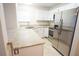 Kitchen boasts white cabinets, stainless steel appliances, granite countertops, and tile flooring at 2936 Antique Oaks Cir # 71, Winter Park, FL 32792
