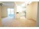 Open living space with sliding glass doors, neutral carpet, and a combined view of the dining area and kitchen at 2936 Antique Oaks Cir # 71, Winter Park, FL 32792