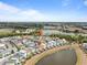 Beautiful aerial view of colorful homes with private pools, backing onto a peaceful lake and lush greenery at 3095 Key Lime Loop, Kissimmee, FL 34747