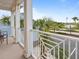 Balcony with charming white railings offers scenic views of surrounding lush greenery at 3095 Key Lime Loop, Kissimmee, FL 34747