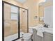 Tiled bathroom featuring a glass-enclosed shower, modern vanity, and contemporary fixtures at 3095 Key Lime Loop, Kissimmee, FL 34747
