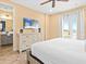 Bright bedroom with a ceiling fan, light wood dresser, and direct access to a private balcony with beautiful views at 3095 Key Lime Loop, Kissimmee, FL 34747