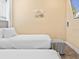 Comfortable twin beds and a tropical wall hanging, enhancing the room's cozy and tranquil atmosphere at 3095 Key Lime Loop, Kissimmee, FL 34747