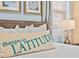 Close-up of a bedroom showcasing beach-themed artwork and a decorative pillow on a comfortable bed at 3095 Key Lime Loop, Kissimmee, FL 34747
