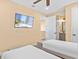 Bedroom includes two twin beds, a flatscreen television, and an ensuite bathroom at 3095 Key Lime Loop, Kissimmee, FL 34747
