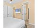 Comfortable bedroom featuring a large TV, and two doors leading to an additional room, providing convenience and privacy at 3095 Key Lime Loop, Kissimmee, FL 34747