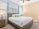 Cozy bedroom featuring coastal decor, a wood-frame bed, and calming blue and yellow color scheme at 3095 Key Lime Loop, Kissimmee, FL 34747