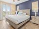 Comfortable bedroom with neutral tones, balcony access, and scenic outdoor views at 3095 Key Lime Loop, Kissimmee, FL 34747