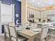 Elegant dining area with seating for six, stylish decor, and plenty of natural light at 3095 Key Lime Loop, Kissimmee, FL 34747