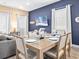 Dining area with seating for six, adjacent to living room and kitchen at 3095 Key Lime Loop, Kissimmee, FL 34747