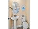 Clean powder room with pedestal sink, modern fixtures, and coastal-themed accents at 3095 Key Lime Loop, Kissimmee, FL 34747