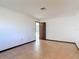 Empty living room featuring tile flooring, base molding, with entry door on opposite wall at 31926 Stearns Dr, Eustis, FL 32736