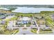 Aerial view of community pool, clubhouse, and surrounding landscaping with parking at 3252 Jackson Bluff Way, Clermont, FL 34711