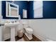 Charming powder room featuring pedestal sink, wainscoting, and stylish decor at 3252 Jackson Bluff Way, Clermont, FL 34711