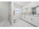Bright bathroom with white marble floors, dual sink vanity, and white cabinets at 3252 Jackson Bluff Way, Clermont, FL 34711