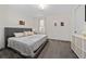 Bedroom features a gray upholstered bed and neutral decor with natural light at 3252 Jackson Bluff Way, Clermont, FL 34711