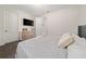 Bedroom with carpet, a patterned comforter, tv, and a storage unit at 3252 Jackson Bluff Way, Clermont, FL 34711