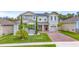 Charming two-story home with a well-manicured lawn and inviting brick-paved driveway at 3252 Jackson Bluff Way, Clermont, FL 34711