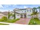 Charming two-story home with a well-manicured lawn and inviting brick-paved driveway at 3252 Jackson Bluff Way, Clermont, FL 34711