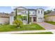 Charming two-story home with a well-manicured lawn and inviting brick-paved driveway at 3252 Jackson Bluff Way, Clermont, FL 34711