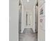 Light and airy hallway with neutral tones, carpet flooring, and closet doors at 3252 Jackson Bluff Way, Clermont, FL 34711