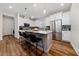 Island kitchen features stainless steel appliances, granite counters and breakfast bar at 3252 Jackson Bluff Way, Clermont, FL 34711
