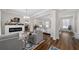 Open-concept living room with fireplace and modern decor, seamlessly connected to kitchen at 3252 Jackson Bluff Way, Clermont, FL 34711