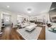 Bright, open living room with hardwood floors, fireplace, with views to the kitchen and dining area at 3252 Jackson Bluff Way, Clermont, FL 34711