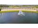 Aerial shot captures Venetian Bay's serene pond, decorative fountain, and elegant entrance sign framed by swaying palms at 3621 Casello Dr, New Smyrna Beach, FL 32168