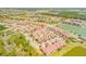 Aerial view of a neighborhood featuring ponds, trees, and residential buildings at 3621 Casello Dr, New Smyrna Beach, FL 32168