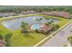 Stunning aerial view of community pool, with lush landscaping and a lake view at 3621 Casello Dr, New Smyrna Beach, FL 32168