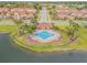 Overhead view of a community pool area with palm trees, lounge chairs, and nearby residences at 3621 Casello Dr, New Smyrna Beach, FL 32168
