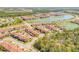 Wide aerial capture featuring a community with numerous lakes, townhomes, and tall buildings at 3621 Casello Dr, New Smyrna Beach, FL 32168