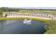 Aerial view features the Venetian Bay entrance sign with a water feature, palm trees, and a glimpse of the golf course at 3621 Casello Dr, New Smyrna Beach, FL 32168